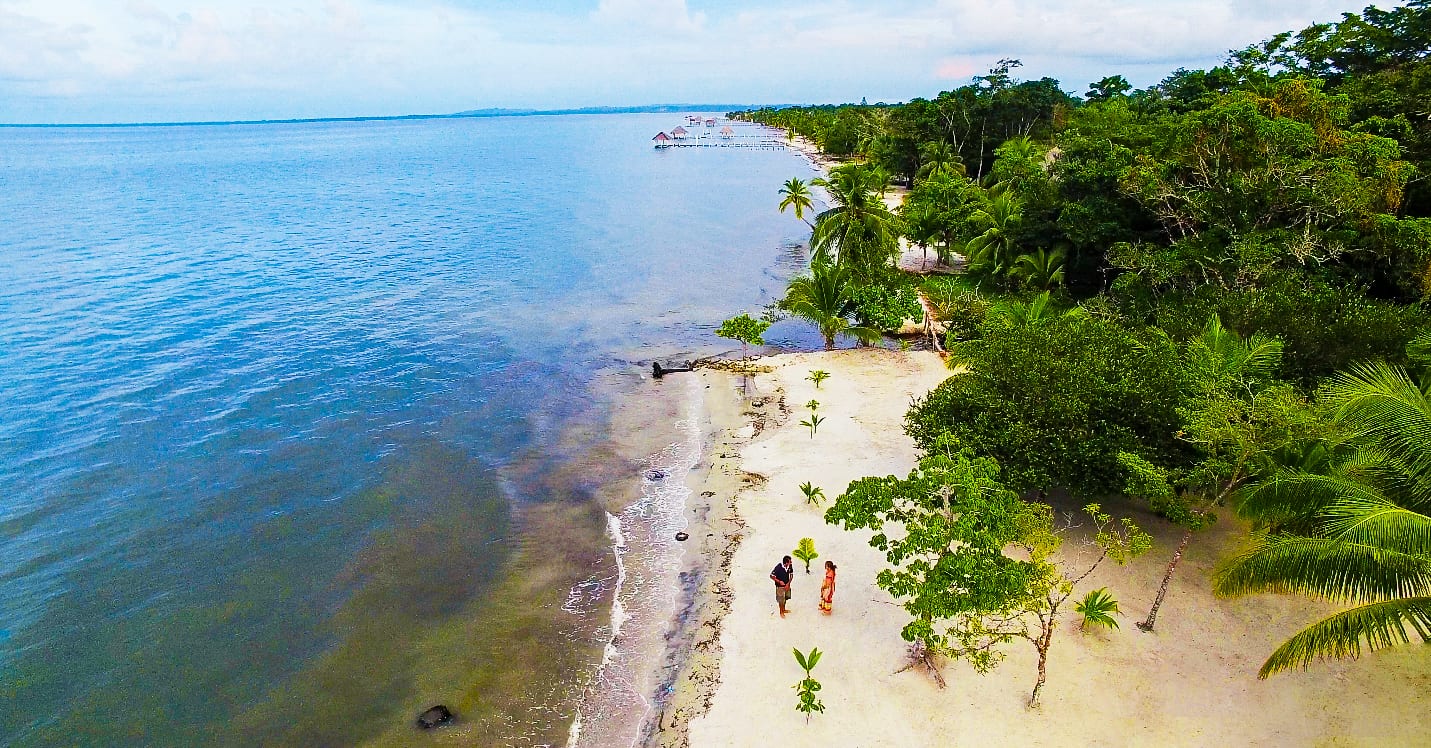 Blue water and beachgoers in the Guatemala Caribbean Coast project.