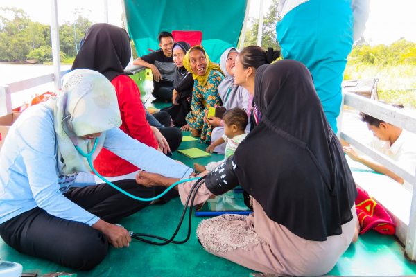 The project's boat-based mobile medical clinic serving remote communities at Rimba Raya.